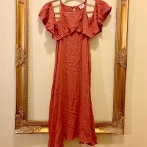 coral dress with cold shoulder and draped sleeves